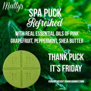 Bath and Body works candles. Image featuring a green circular spa puck against a background of lush green leaves. The text reads: "Refreshed Spa Puck, refreshed with real essential oils of pink grapefruit, peppermint, and shea butter. Thank Puck It's Friday. 180g Net Weight 80mm x 80mm x 23mm.”