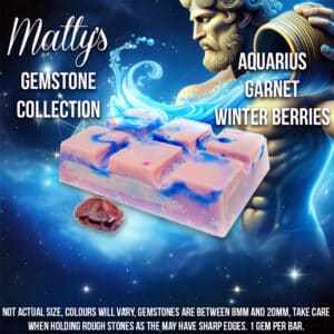 A promotional image features a bar of soap with purple and pink hues from "Matty's Gemstone Collection." The soap is named "Aquarius Garnet Winter Berries" and includes actual garnet gemstones. An image of a gemstone and a deity-like figure holding water are also shown.